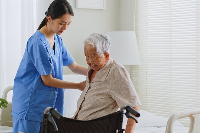 A female nurse assisting for an elderly man.